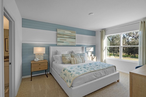 Primary bedroom with side tables and window