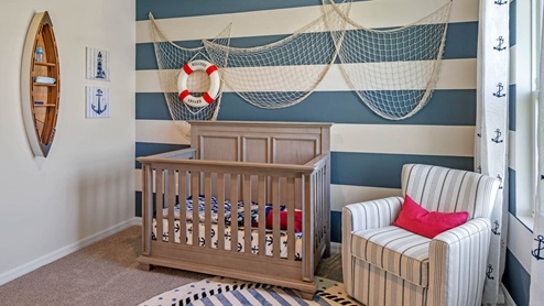 Nursery room with crib and chair