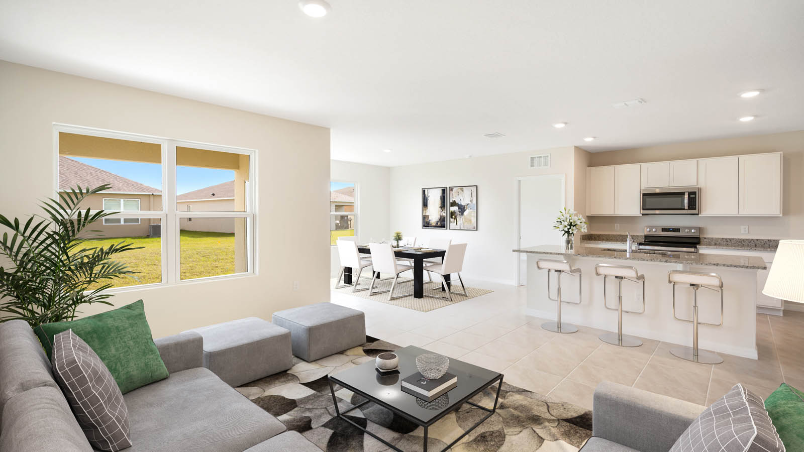 Virtually staged living room overlooking the kitchen and dining room