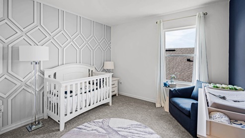 Spare room nursery with crib and changing table