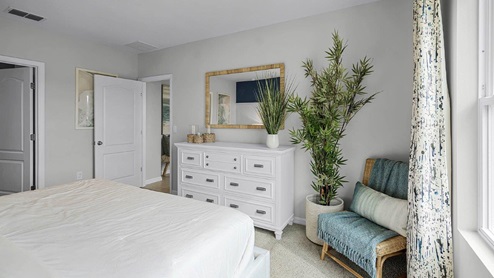 Primary bedroom with vanity, Vanity mirror and chair