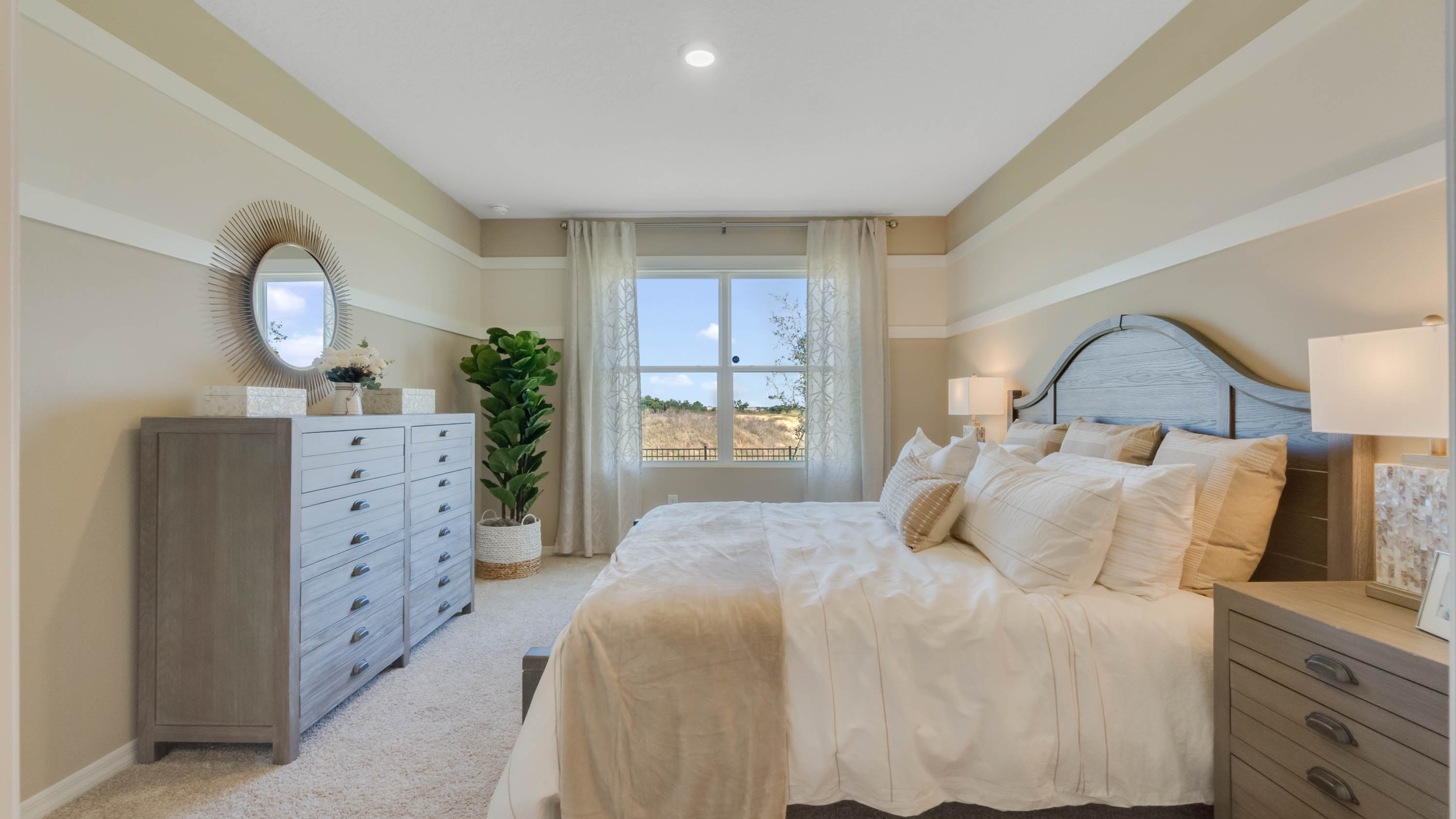 Primary bedroom with vanity and queen size bed