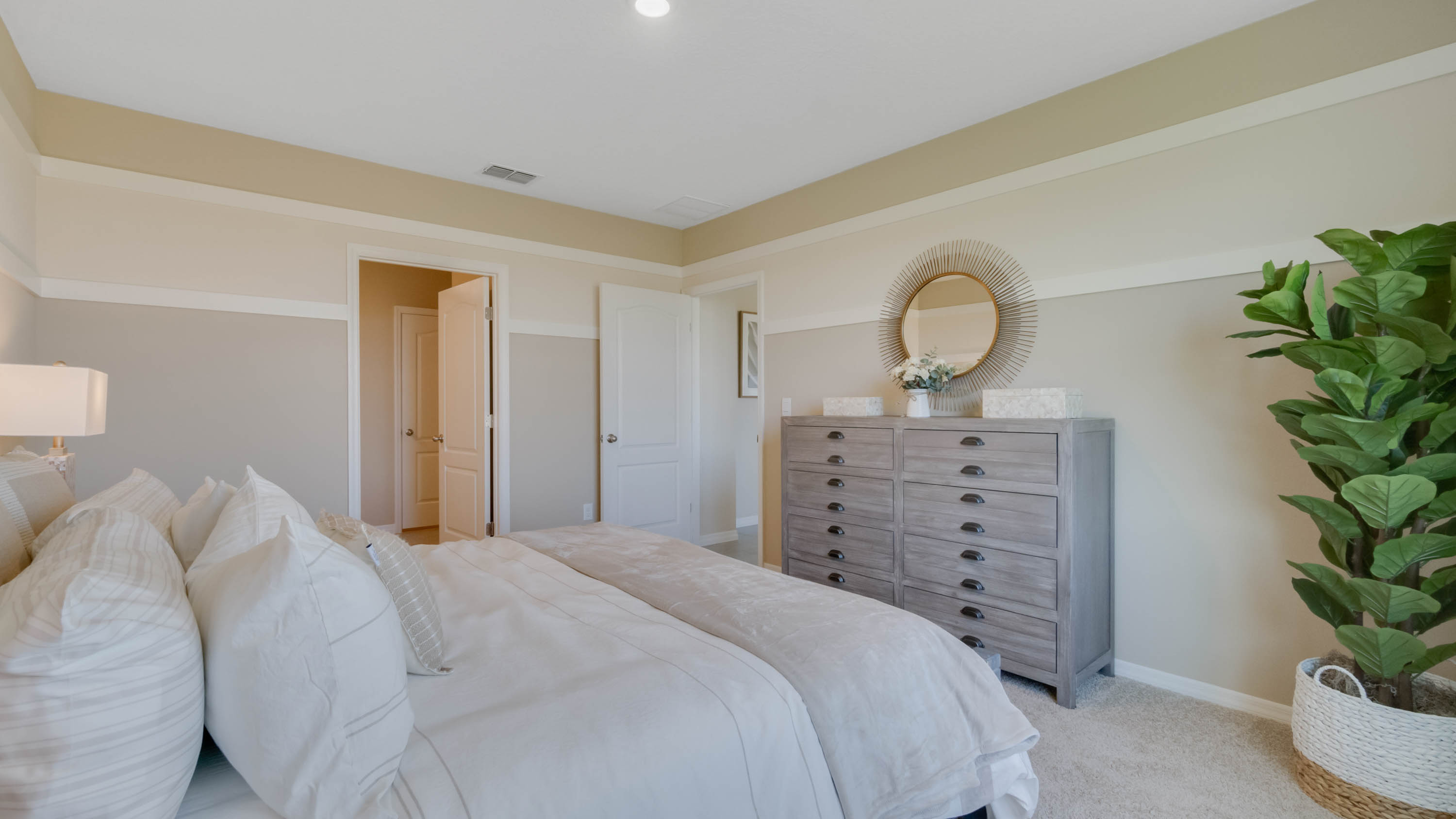 Primary bedroom with vanity and bed