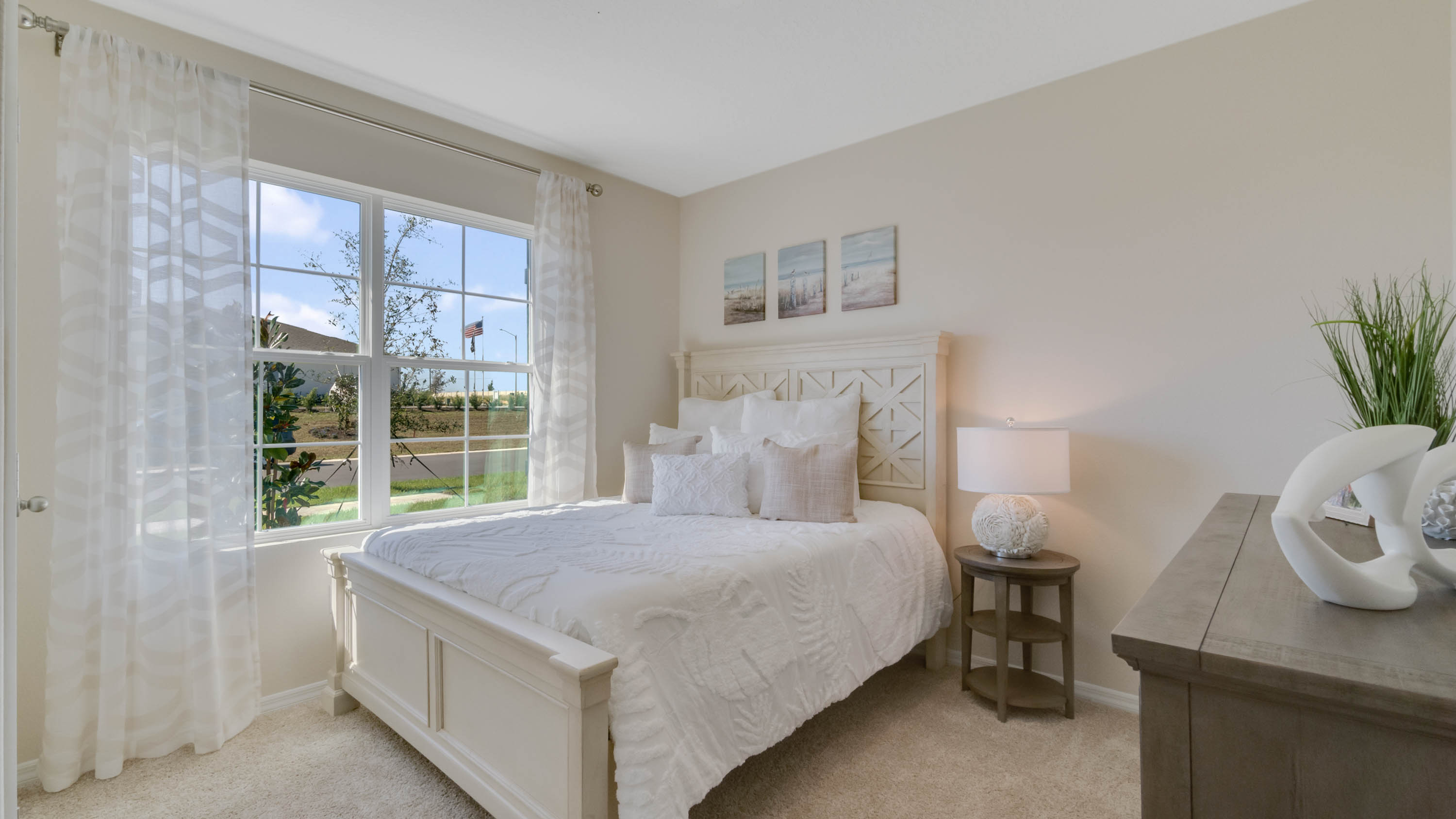 second bedroom with vanity and window to the side of the home
