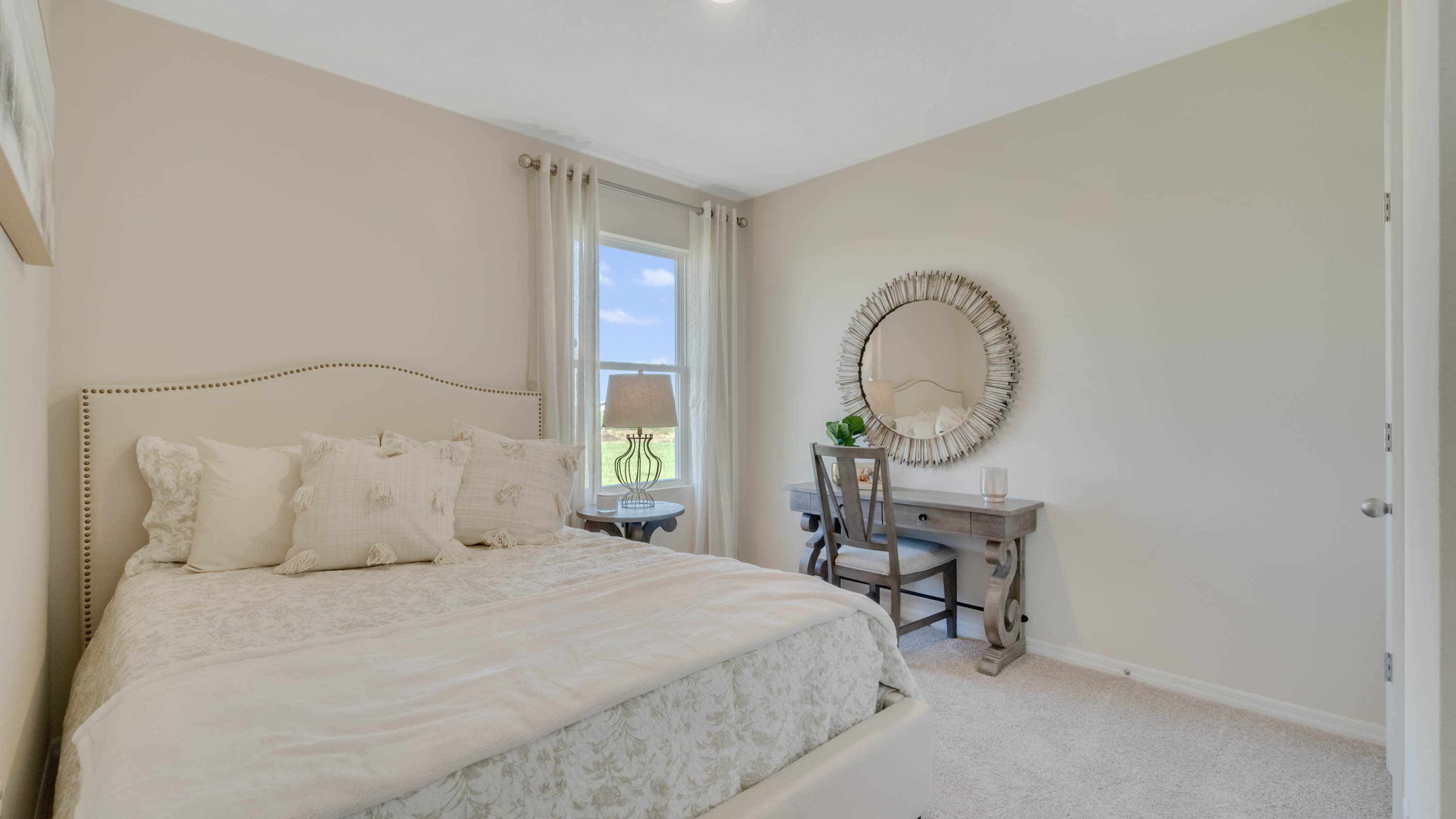 second bedroom with carpet and vanity