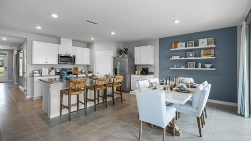 Dining room area with the kitchen and the dining table to the right