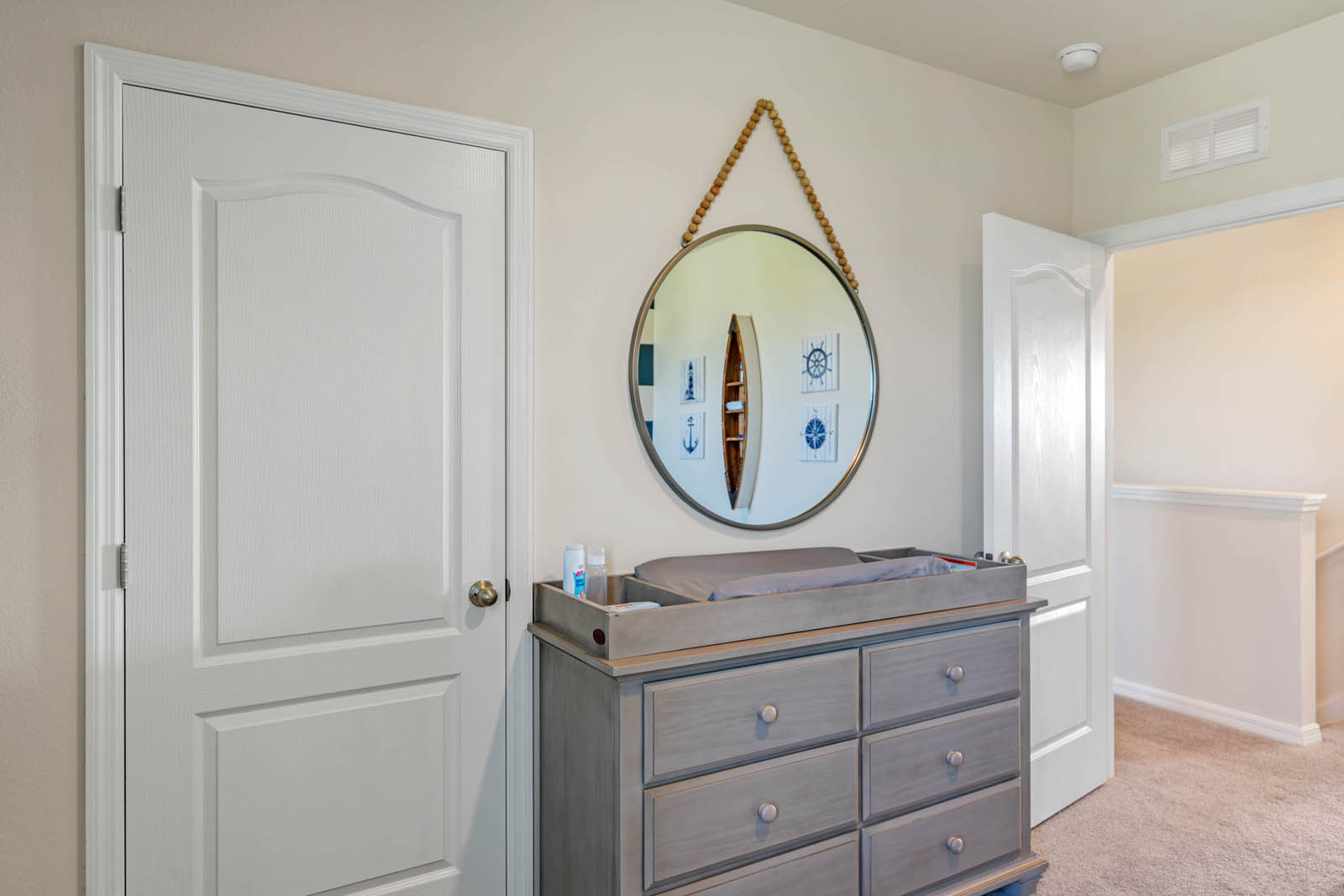Nursery dresser and closet entrance