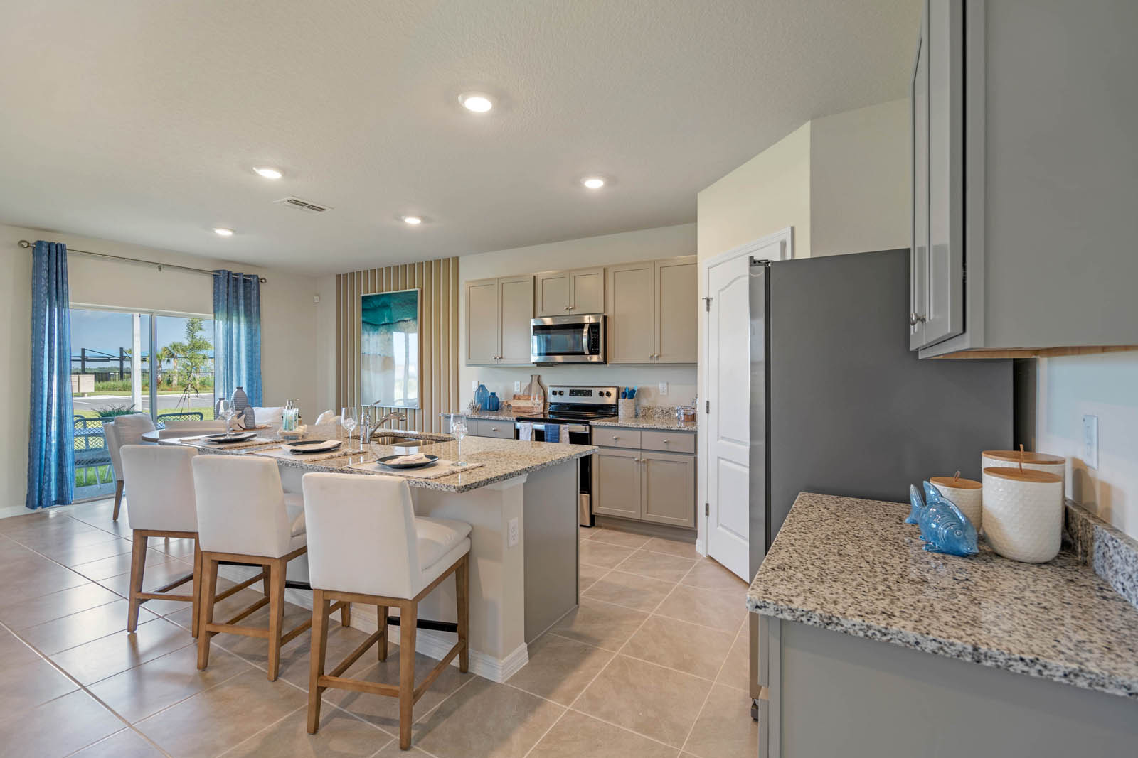 Kitchen with island and bar stools and ceramic tile