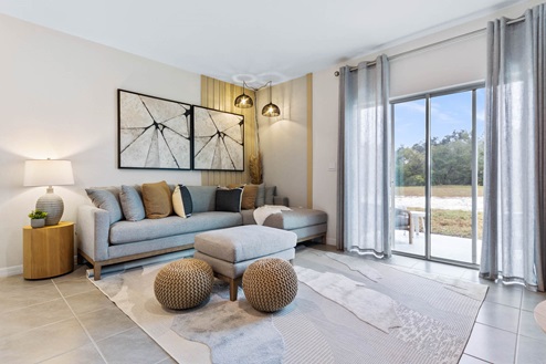 Living room with sectional couch and sliding glass doors