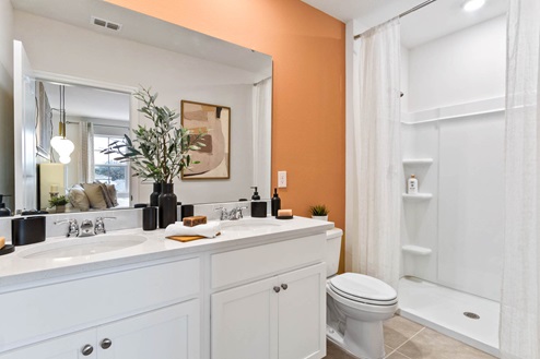 Primary bathroom with walk in shower and double sink vanity