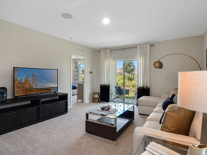 living room with access to the primary bedroom and patio doors