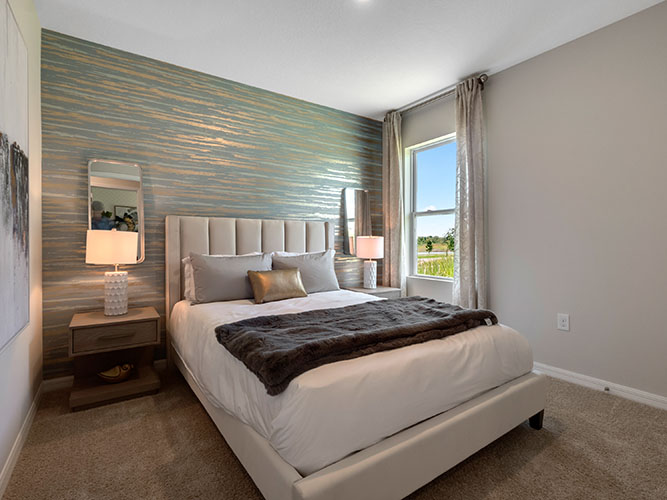 Guest bedroom with queen bed and carpet