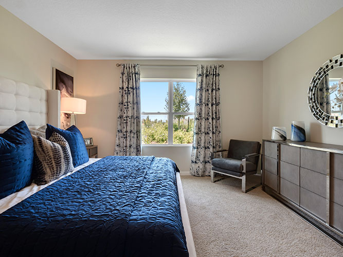 Spacious primary bedroom with king size bed