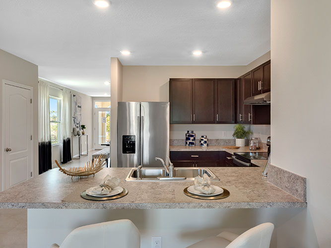 Kitchen peninsula with built in sink and eating room