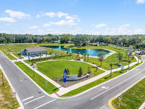 aerial shot of the sales center home by the lake