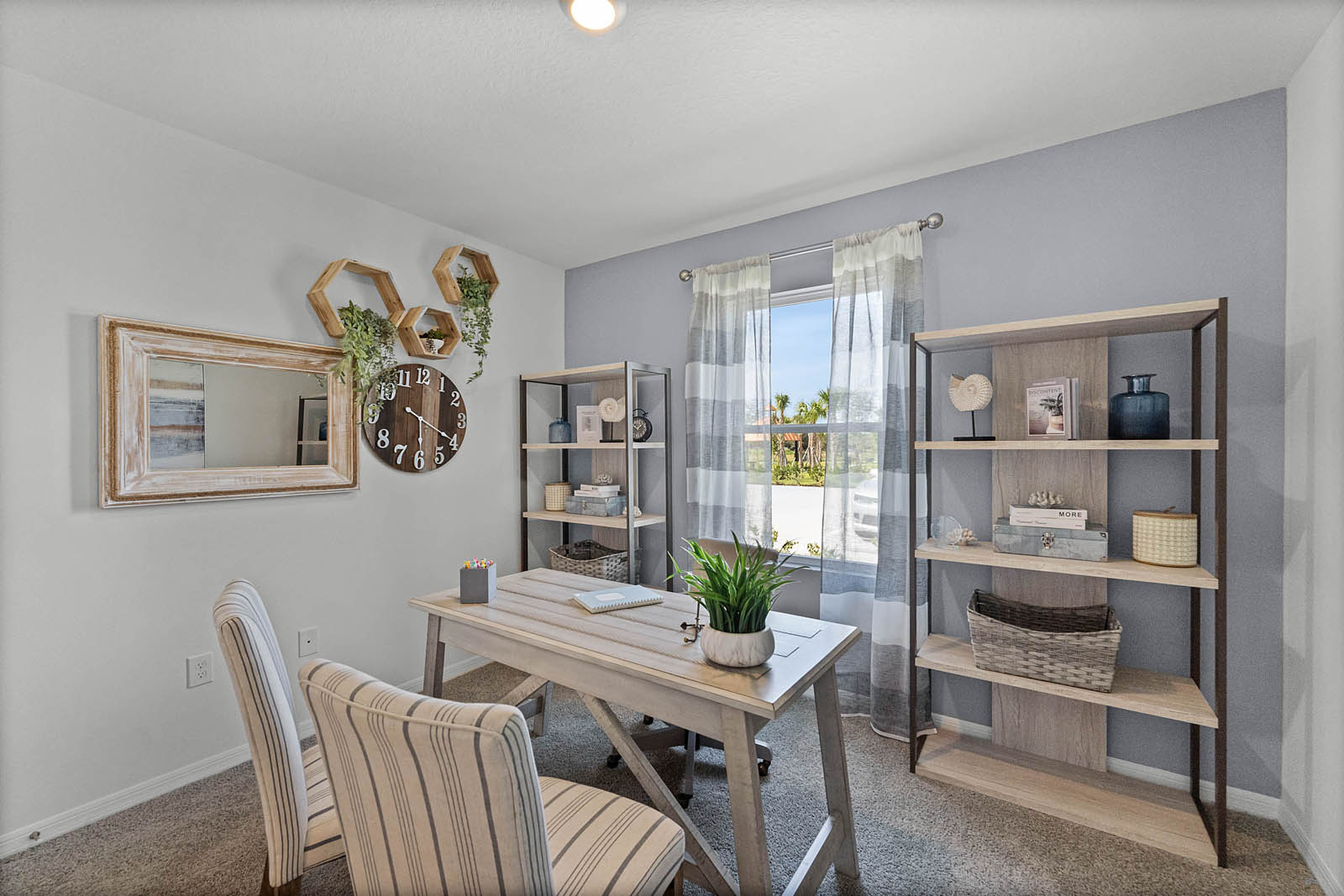 Guest bedroom modeled as an office with a desk and chairs.