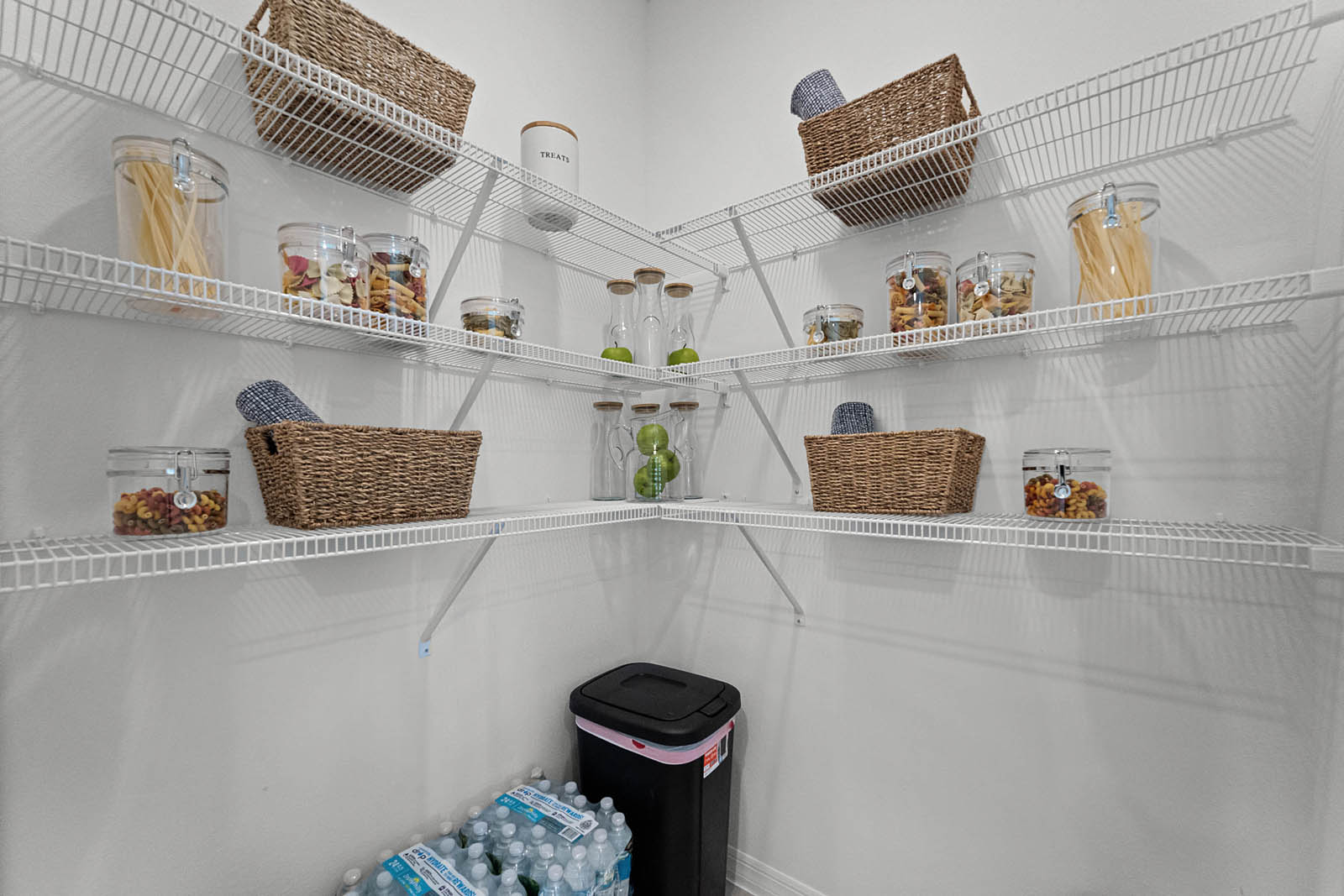 Walk in pantry with multiple shelving.