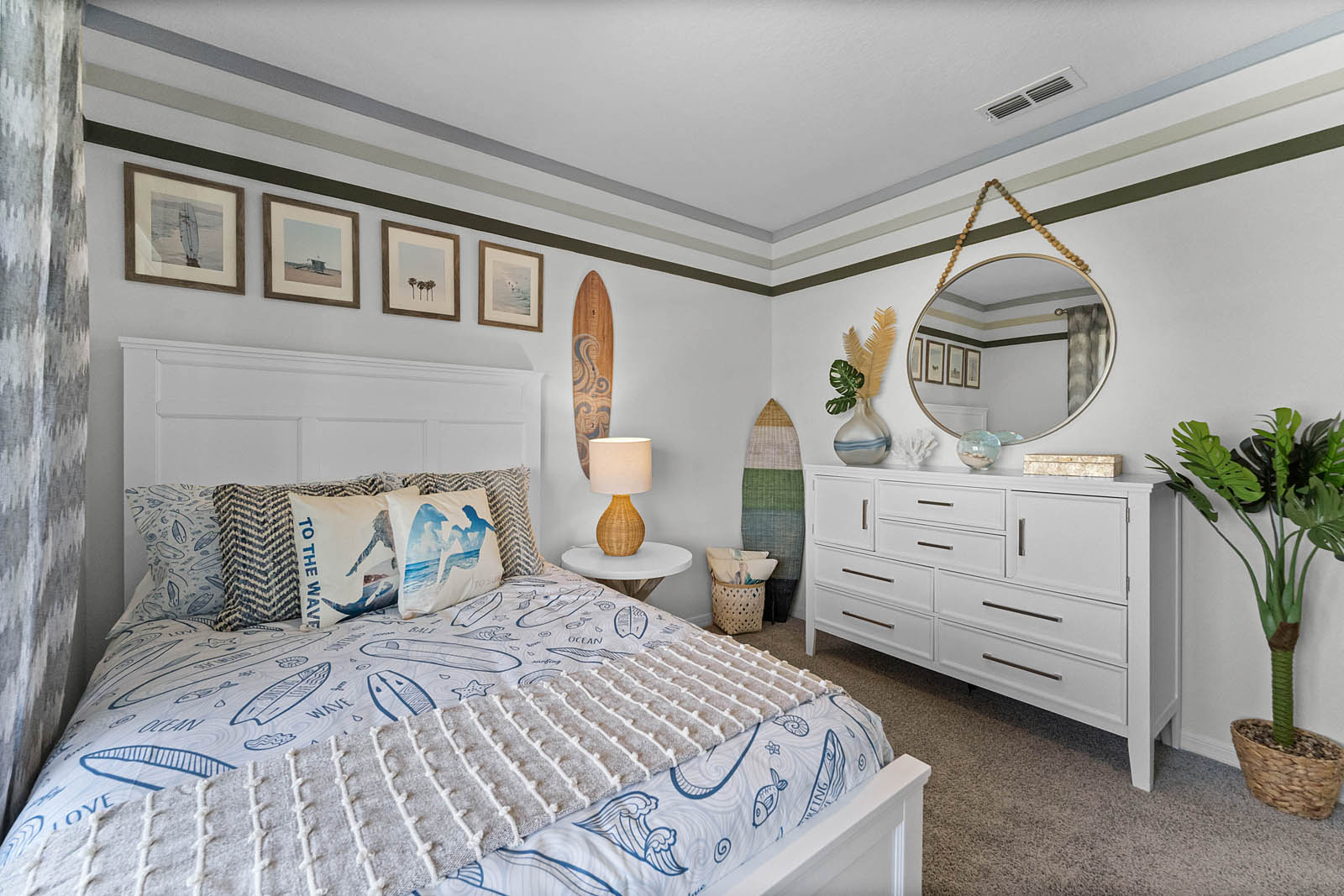 guest bedroom with a full sized bed with a mirror above vanity.