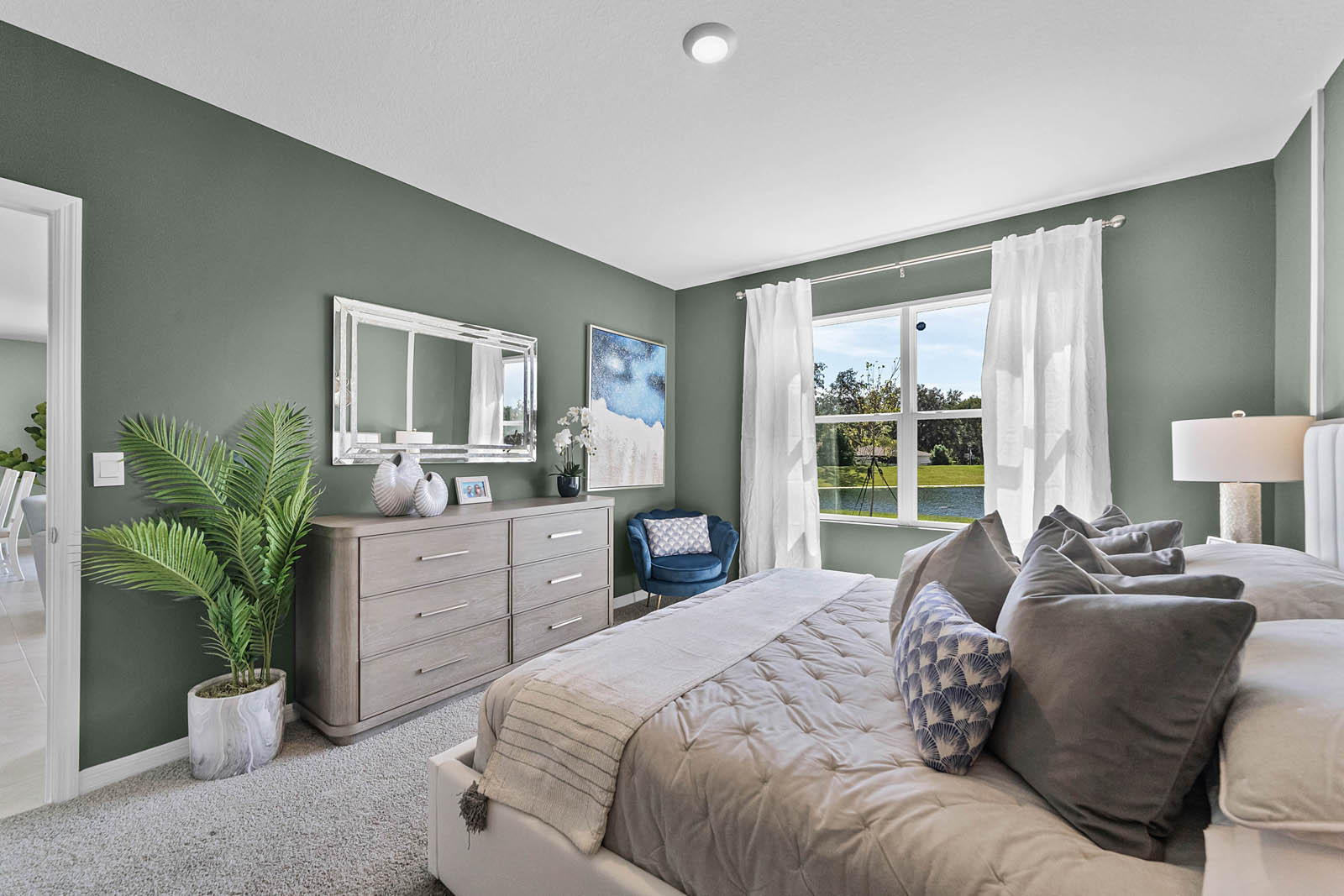 Primary Bedroom with night stands, bed and vanity.