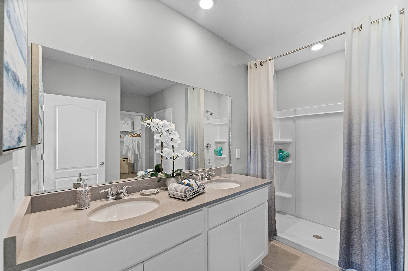 primary bathroom with double sink and walk in shower.