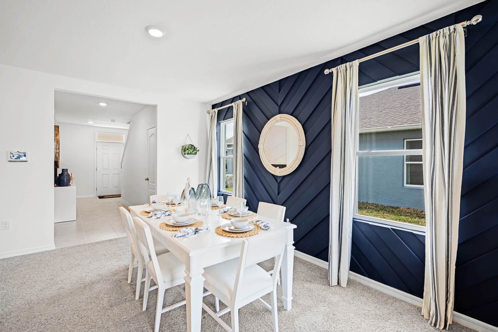 spacious dining area with adjacent hallway to upstairs