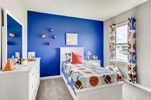 second-floor guest room with two office stations and carpet flooring