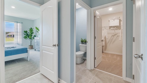 Primary bathroom with attached walk in closet