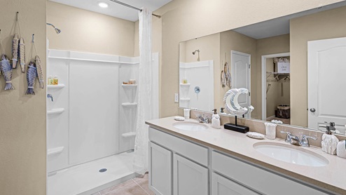Primary bathroom with double vanity dink and walk in shower