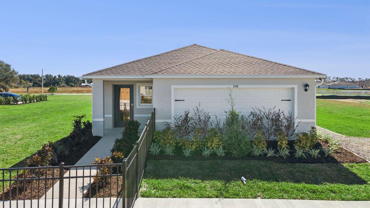 Exterior of a single family home model with a front fence