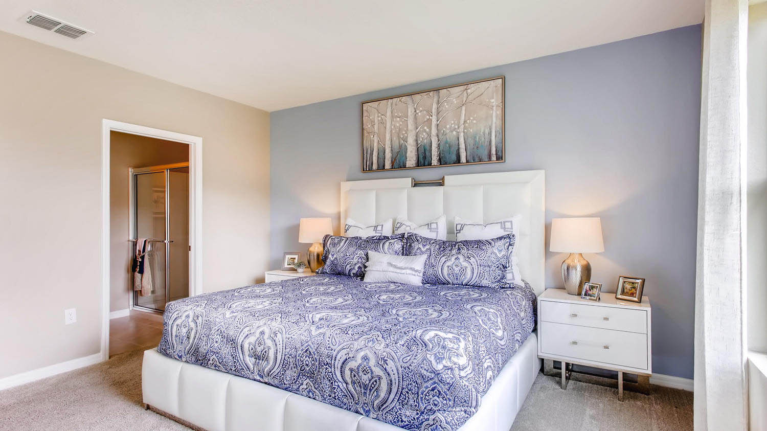 Primary bedroom with door leading to the primary bathroom