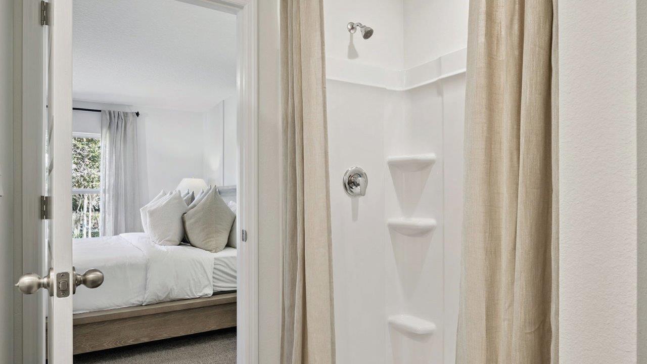 Primary bedroom showing bed and dresser