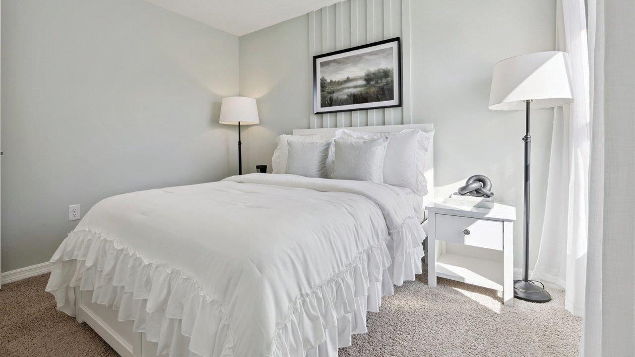 guest bedroom with twin bed and carpet flooring