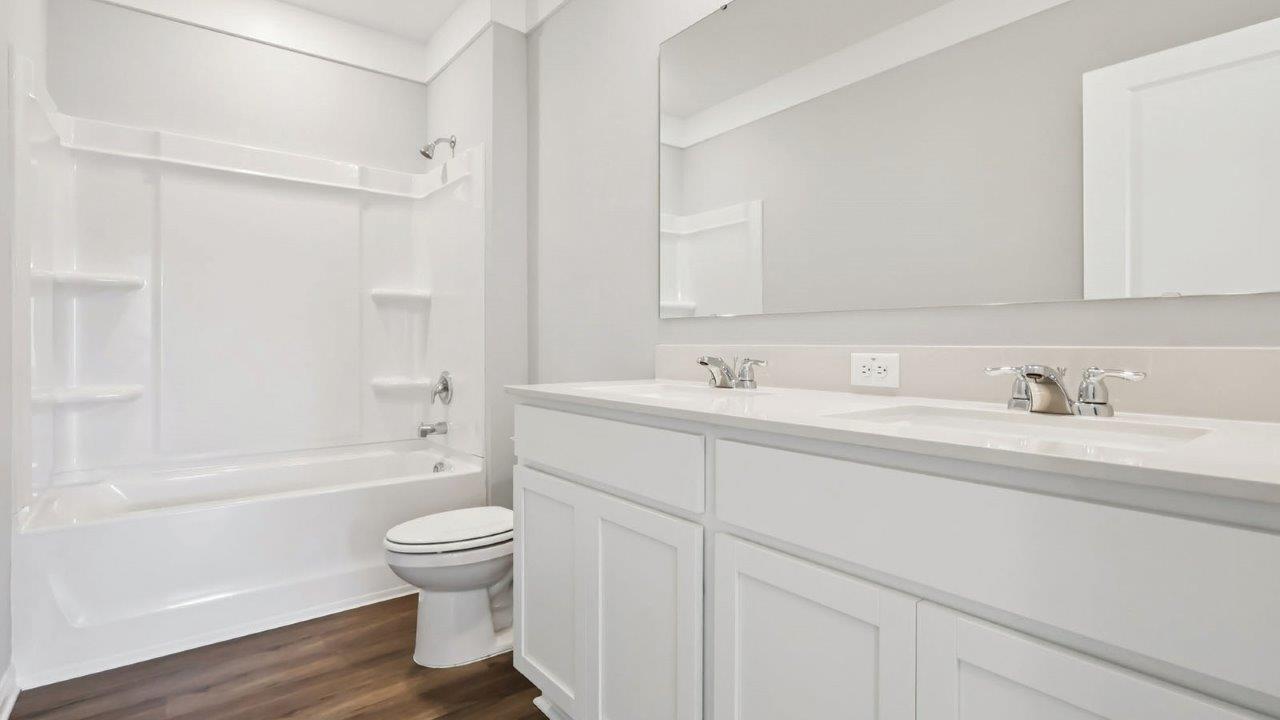 Guest bathroom with dual vanity sink and tub