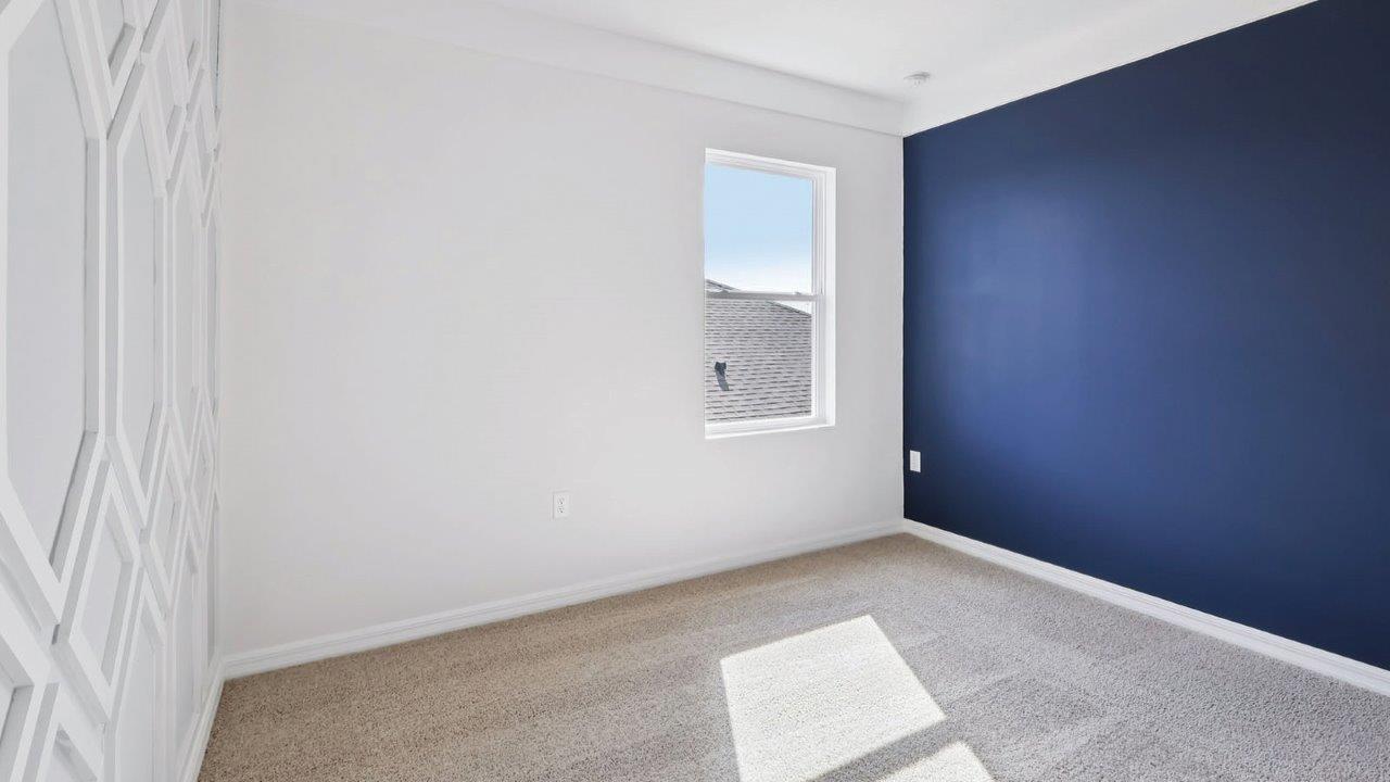 Guest bedroom with wall accents and window