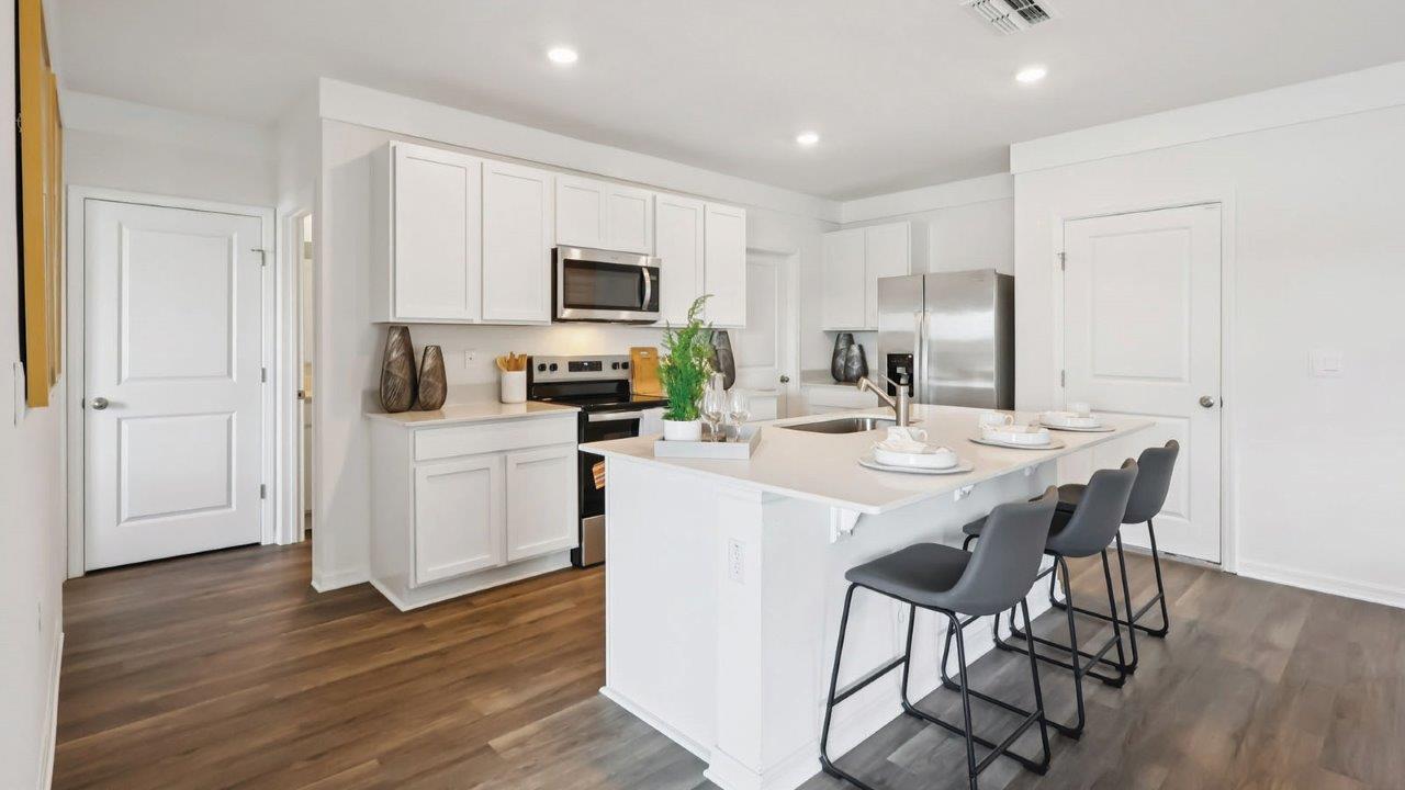 Kitchen with stainless steel appliances and garage entrance
