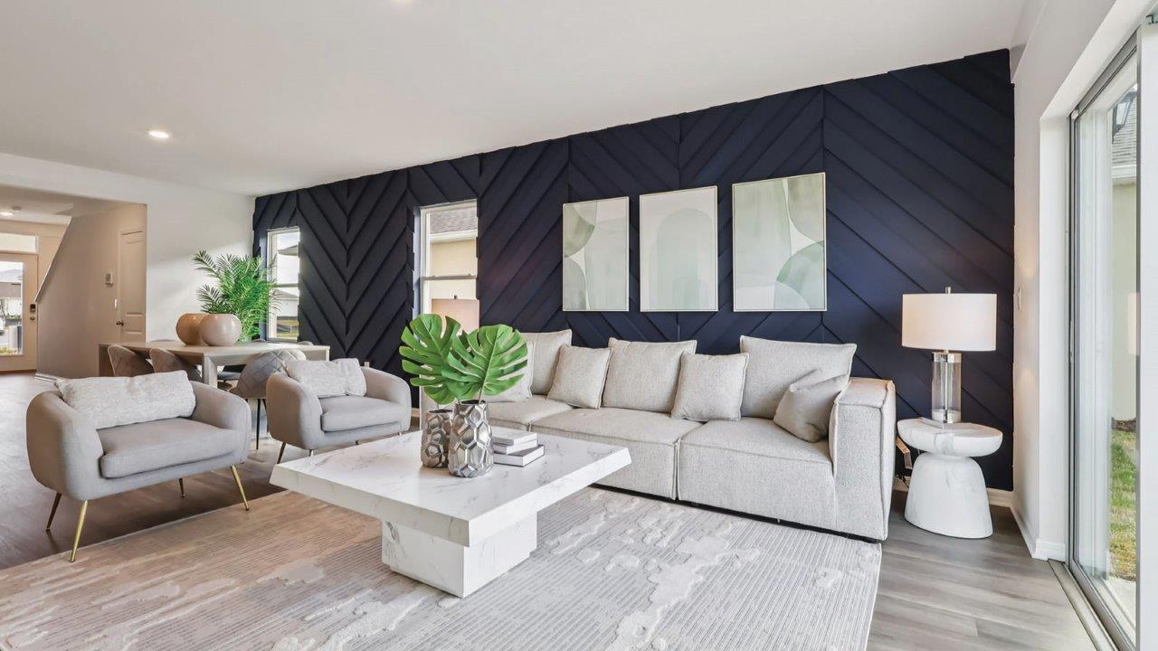 Living room with couch and chairs and wall art