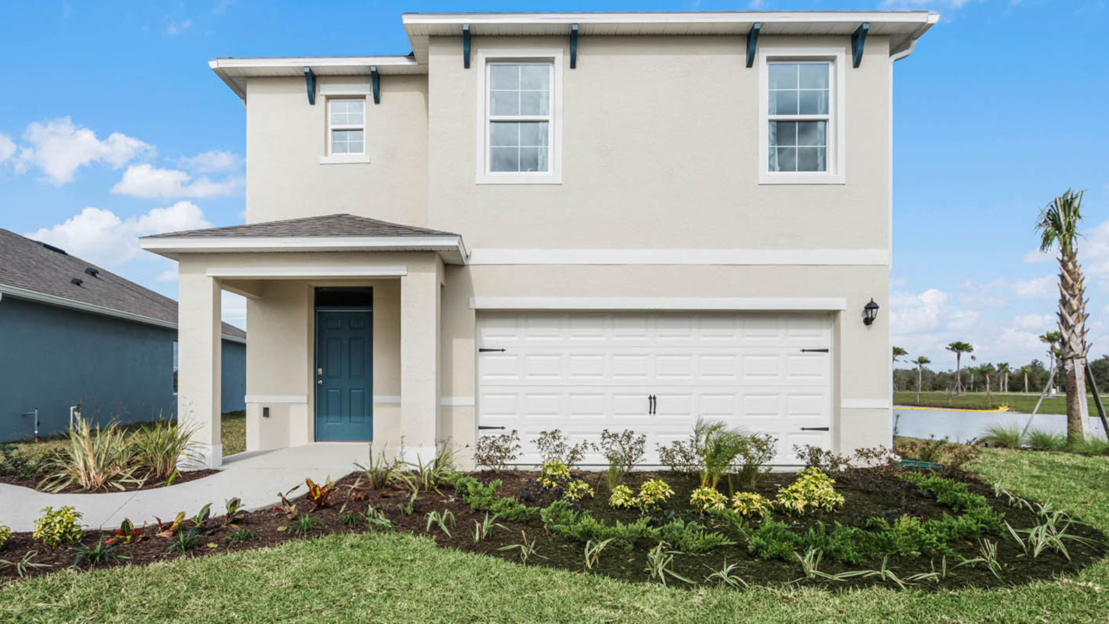 Two-story home with two-car garage with a covered door
