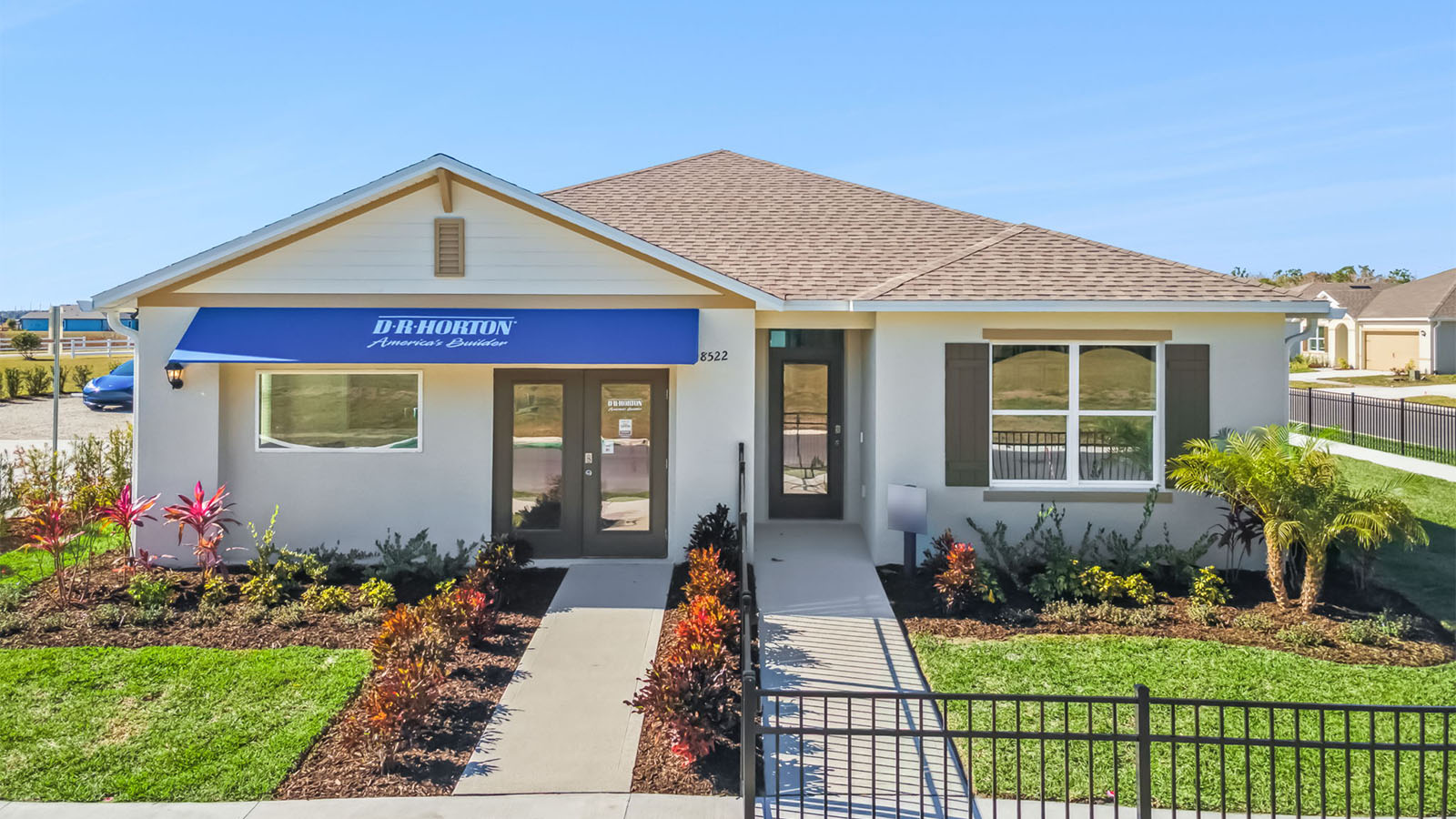 Exterior of a single family home model with a front fence