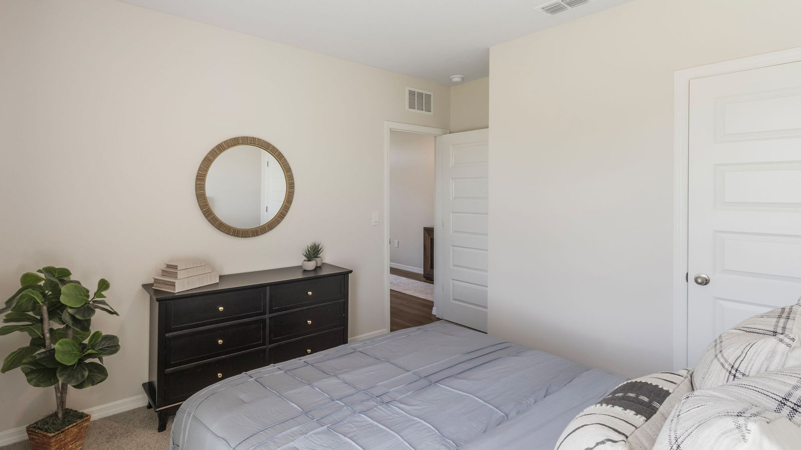 Guest bedroom with a full bedroom and vanity