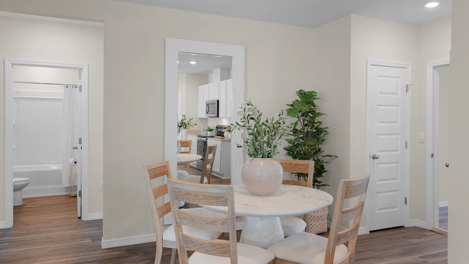 Spacious kitchen with large island, quartz counter tops and sleek gray cabinets