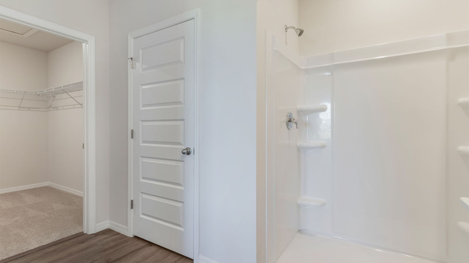 Primary bathroom with a walk in closet