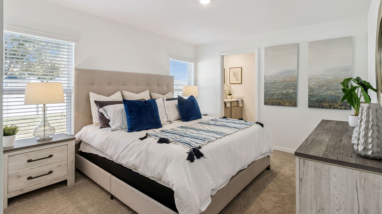 Primary bedroom with king size bed and ensuite bathroom