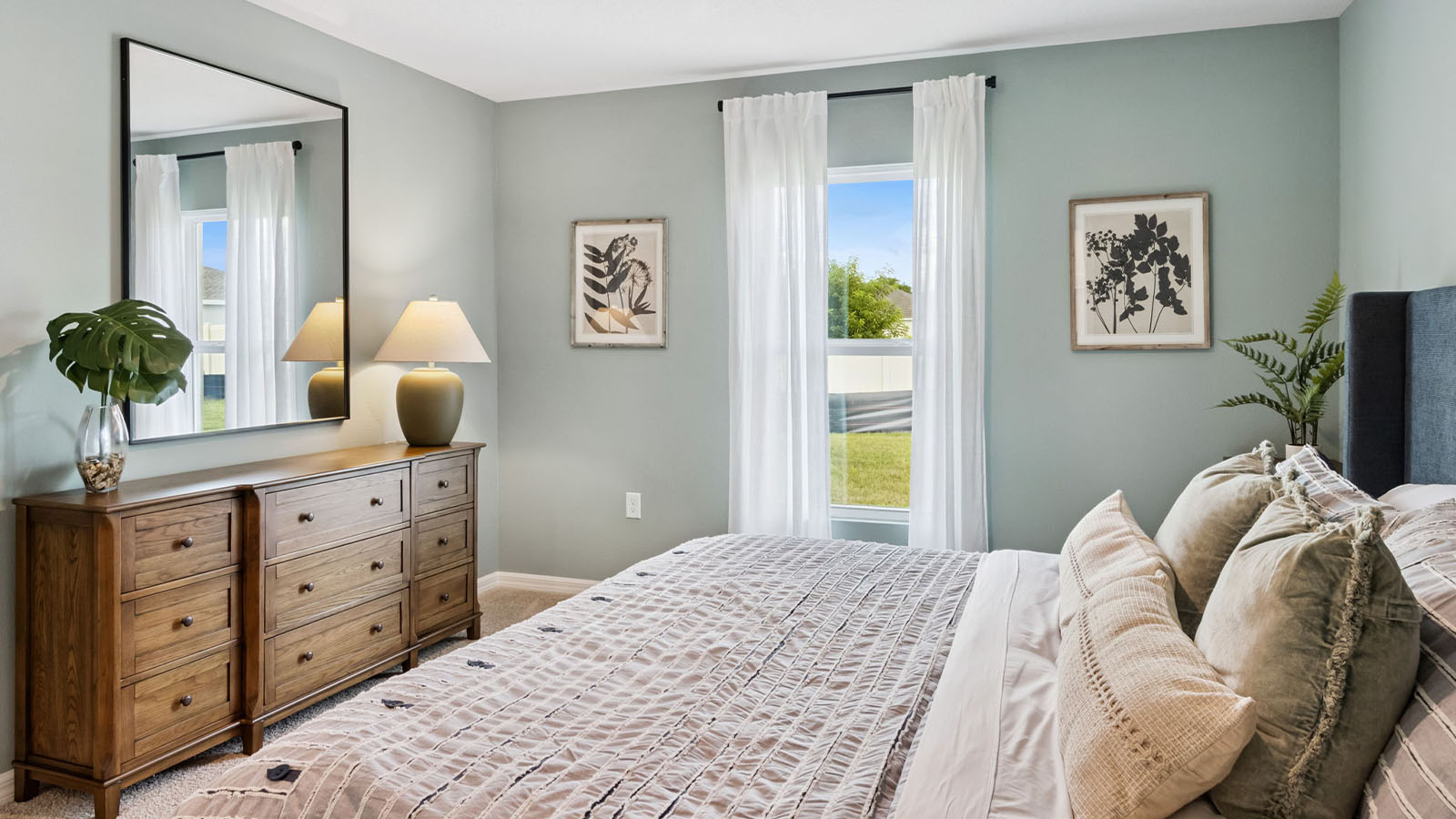Primary bedroom with window overlooking backyard