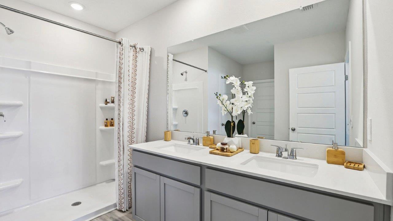 primary bathroom with dual vanity sink