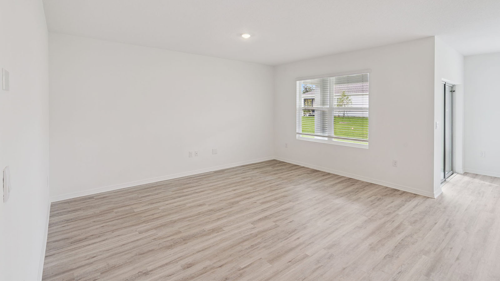 Living Room with luxury vinyl plank flooring and view to back yard