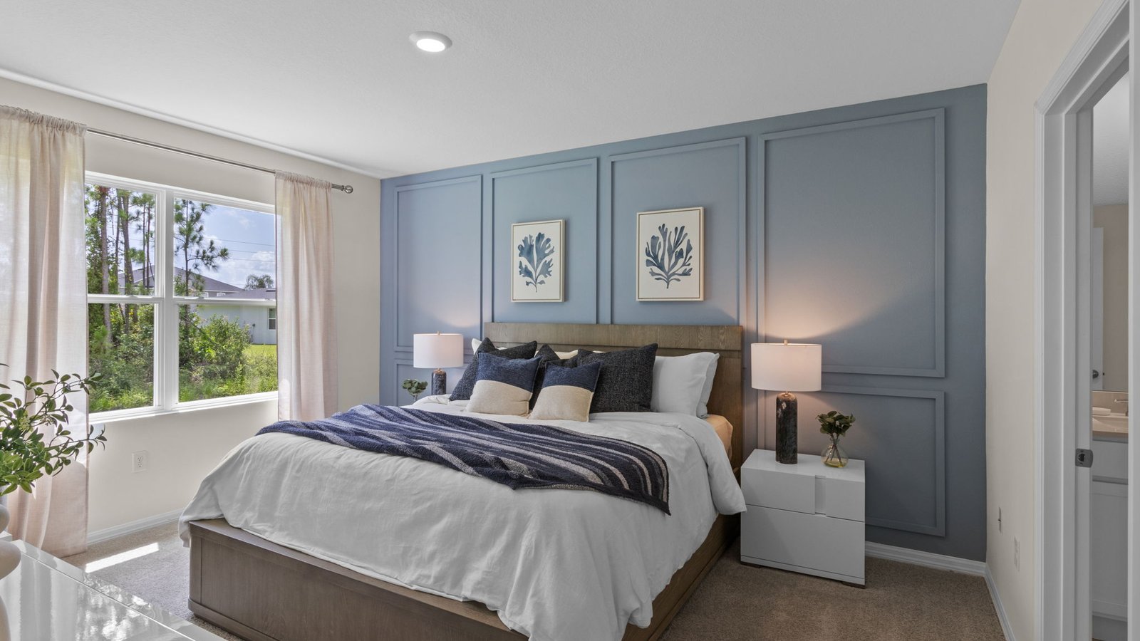 Primary bedroom with a queen bed with carpet flooring