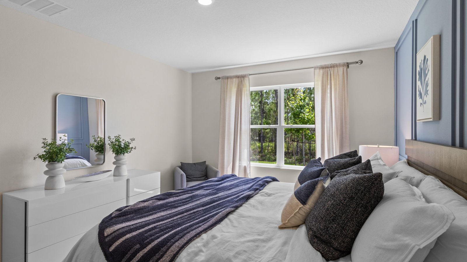 Primary bedroom with a queen bed with carpet flooring