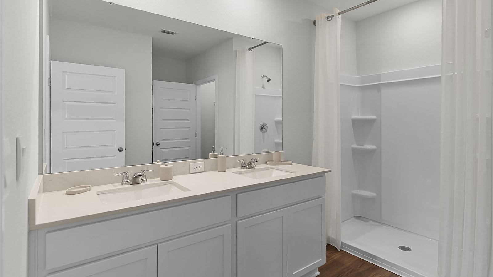Primary bathroom with dual vanity and walk-in shower