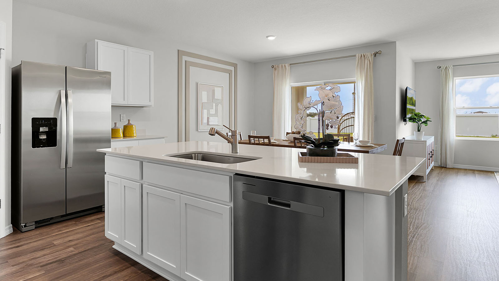 Kitchen with large island and view of dining room