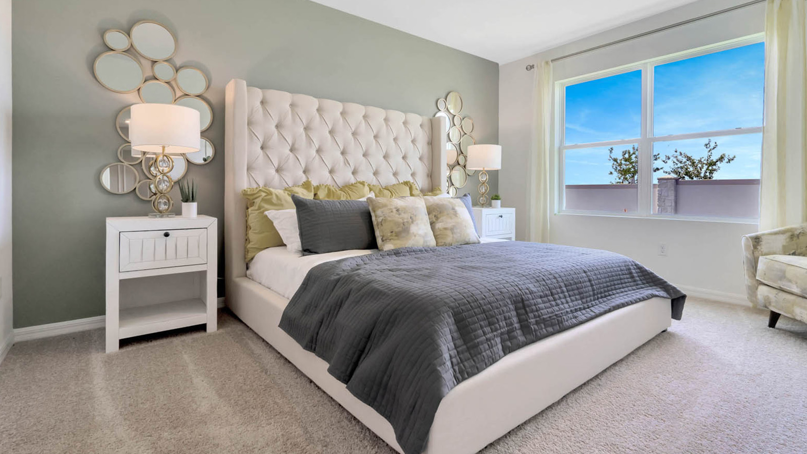 Primary bedroom bed with carpet throughout the room